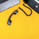A yellow desk top looking down at a laptop and VOIP phone